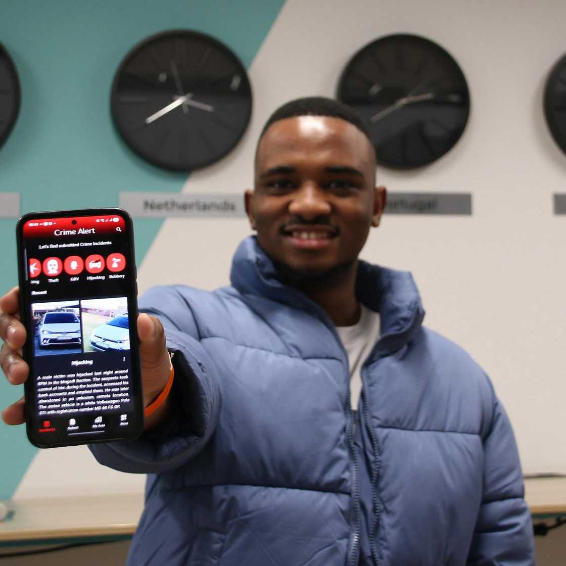 Software developer Sphephelo Mabena holds up a smartphone displaying the Crime Alert app, which provides real-time crime updates and reporting features for South Africans. Software developer Sphephelo Mabena holds up a smartphone displaying the Crime Alert app, which provides real-time crime updates and reporting features for South Africans.