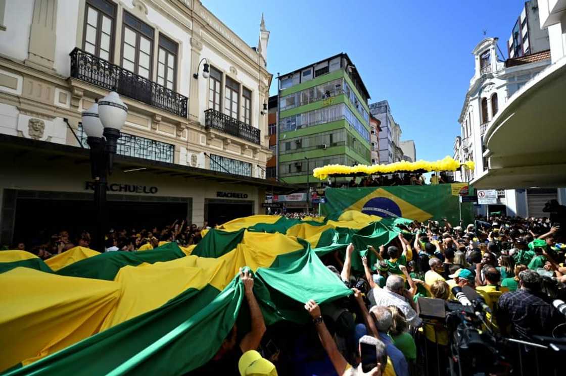 Supporters of Brazil's President Jair Bolsonaro  celebrate the launch of the embattled far-right incumbent's bid for a second term in Juiz de Fora, in the state of  Minas Gerais, Brazil, on August 16 2022 Supporters of Brazil's President Jair Bolsonaro  celebrate the launch of the embattled far-right incumbent's bid for a second term in Juiz de Fora, in the state of  Minas Gerais, Brazil, on August 16 2022