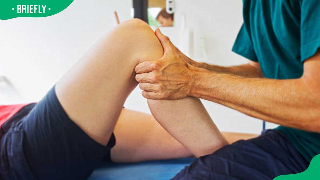 A physiotherapist working on a patient