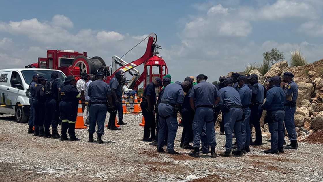 Police waiting for miners to resurface.