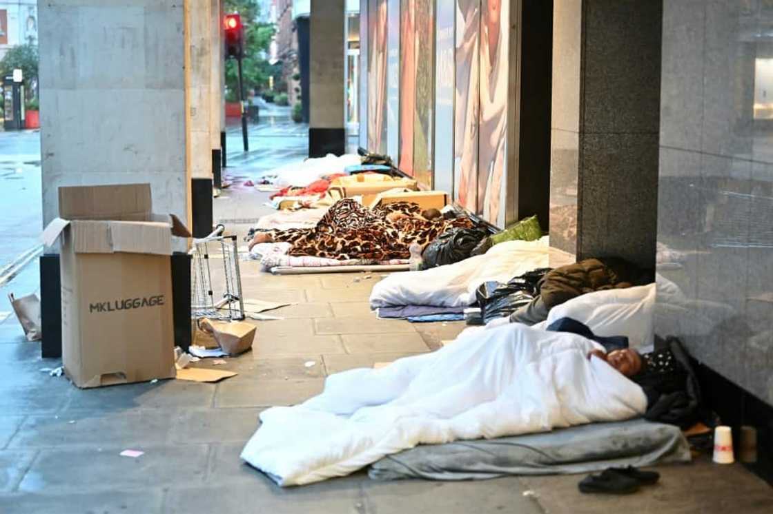 Rough sleepers lay in their makeshift beds outside closed shops, at daybreak on Oxford Street in London on August 2, 2023. Homeless has soared across Britain where a cost of living crisis has left many struggling to make ends meet. The CPRE charity said on December 26, 2023, that the number of rural homeless in England had risen by 40 percent since 2018.