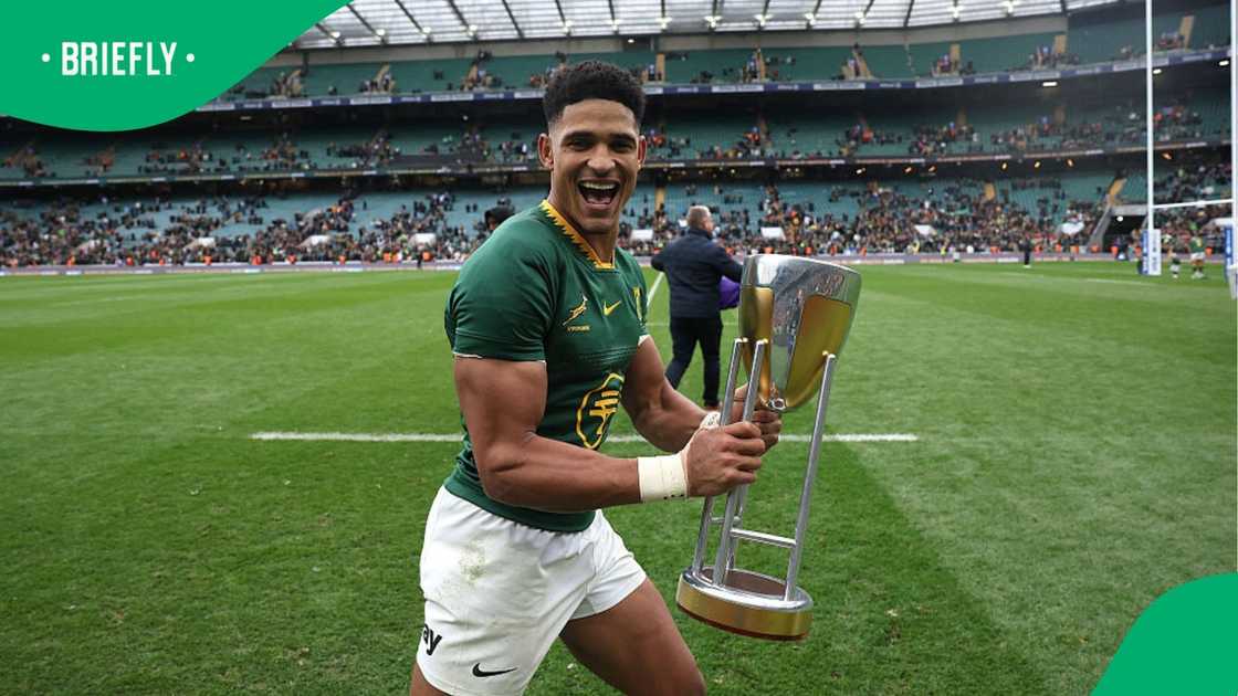 Sacha Feinberg-Mngomezulu celebrates with the Rugby Championship trophy. Sacha Feinberg-Mngomezulu celebrates with the Rugby Championship trophy.