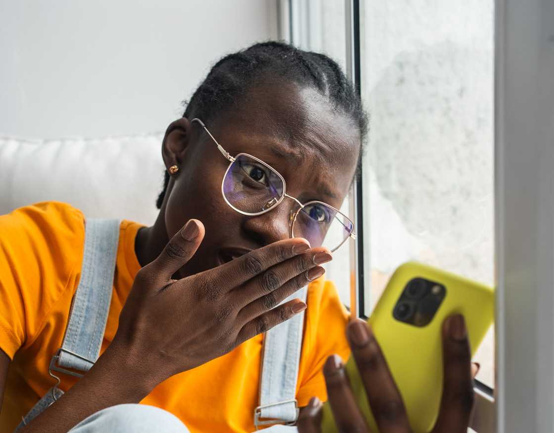 Woman shocked at the comments on her phone. Woman shocked at the comments on her phone.