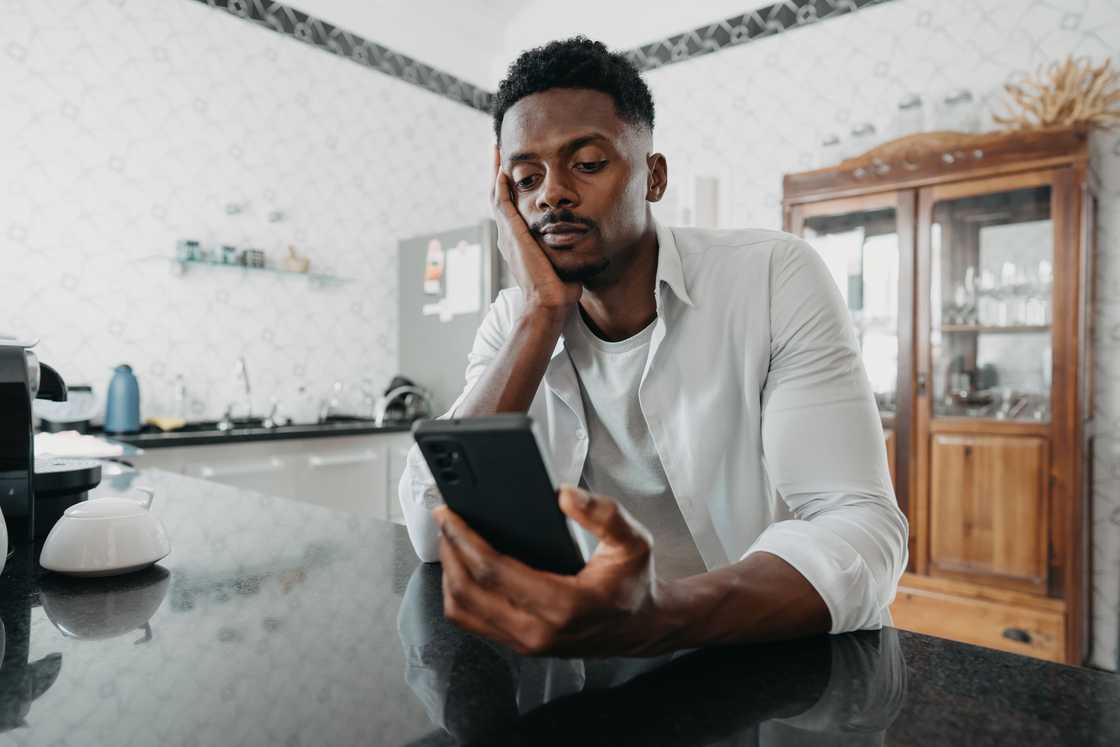 A man uses his phone A man uses his phone