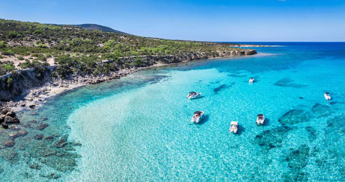 Drone view of the Blue Lagoon in Cyprus, with white anchored boats, Akamas Peninsula. Drone view of the Blue Lagoon in Cyprus, with white anchored boats, Akamas Peninsula.