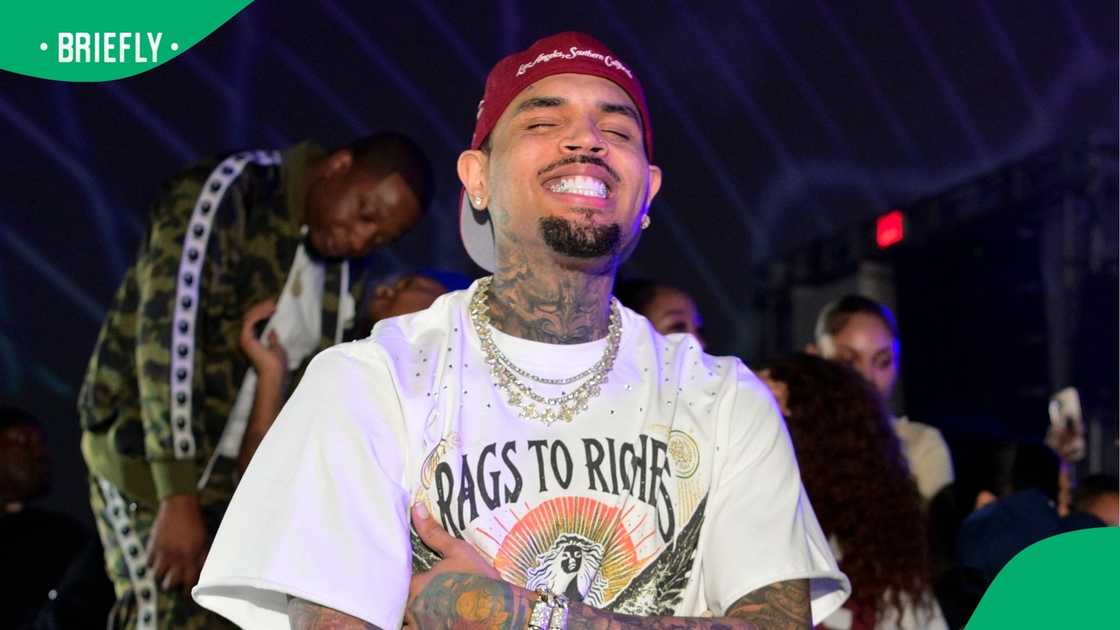 A married woman kissed Chris Brown with her husband standing in the crowd