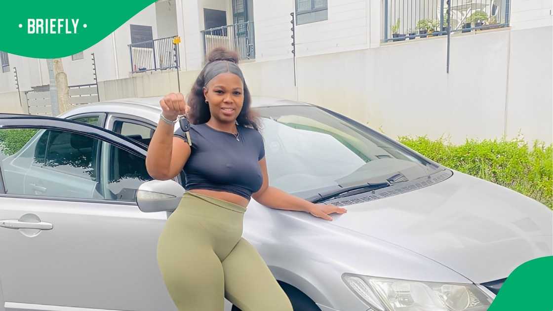 A woman was allegedly fired from her job as a garage cashier after buying herself a car.