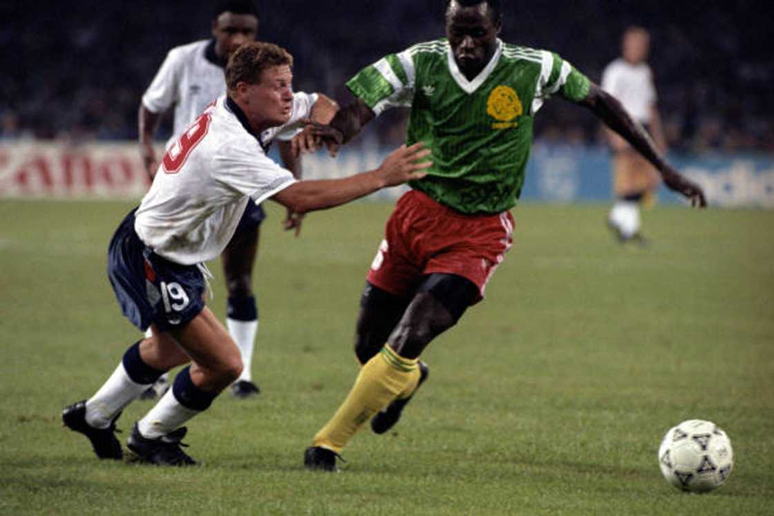 Cameroon's Emmanuel Kundé evades England’s Paul Gascoigne during a memorable World Cup clash, showcasing his trademark composure and class Cameroon's Emmanuel Kundé evades England’s Paul Gascoigne during a memorable World Cup clash, showcasing his trademark composure and class