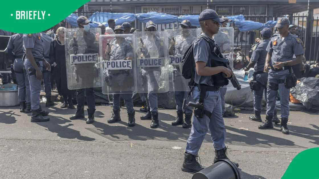 South African Police Service (SAPS) officers stand guard during a demonstration against undocumented migrants by March and March Movement in Durban, on September 3, 2026 South African Police Service (SAPS) officers stand guard during a demonstration against undocumented migrants by March and March Movement in Durban, on September 3, 2026