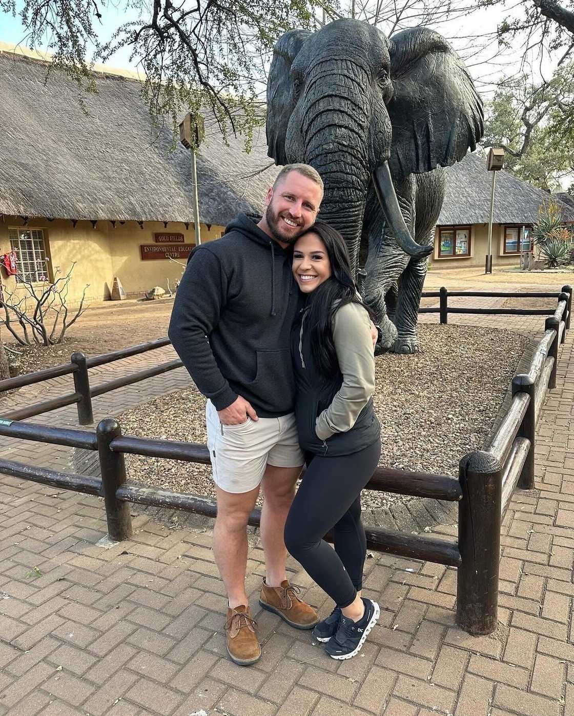 An Afrikaner husband and his American wife posed in a picture.