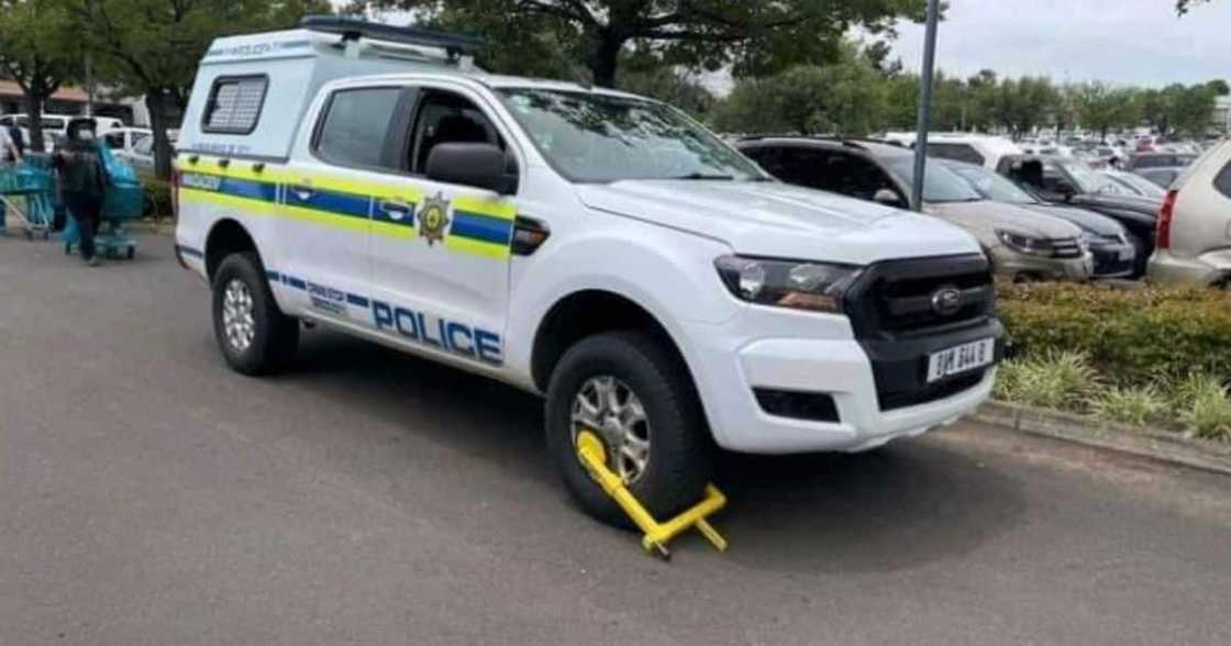 police, van, clamped, fine, fee, SA, men in blue, wheels, steering wheel, brakes, white, cops