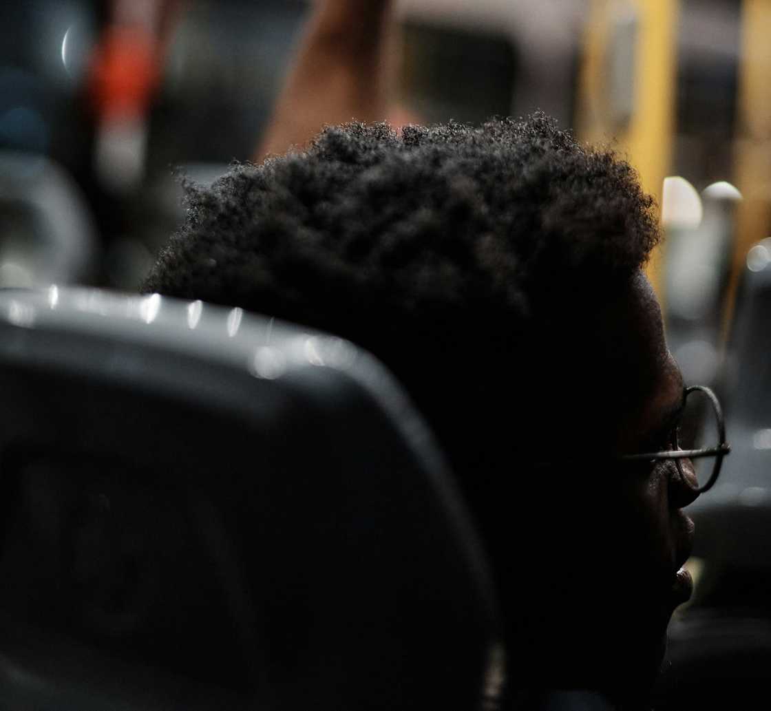 A young student talking to someone in a bus
