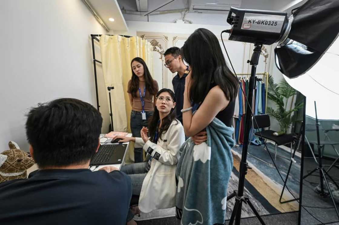 Instructor Wang Yaxuan (C) giving feedback after a student's livestream on TikTok Instructor Wang Yaxuan (C) giving feedback after a student's livestream on TikTok