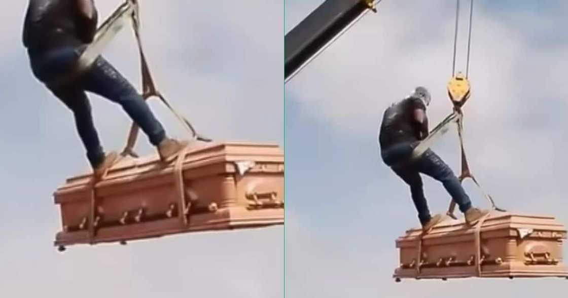 A man performs a daring stunt on top of a casket descending from the sky at funeral