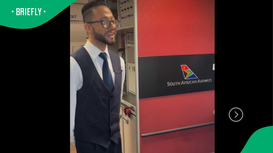 An SAA flight attendant welcoming passengers boarding.