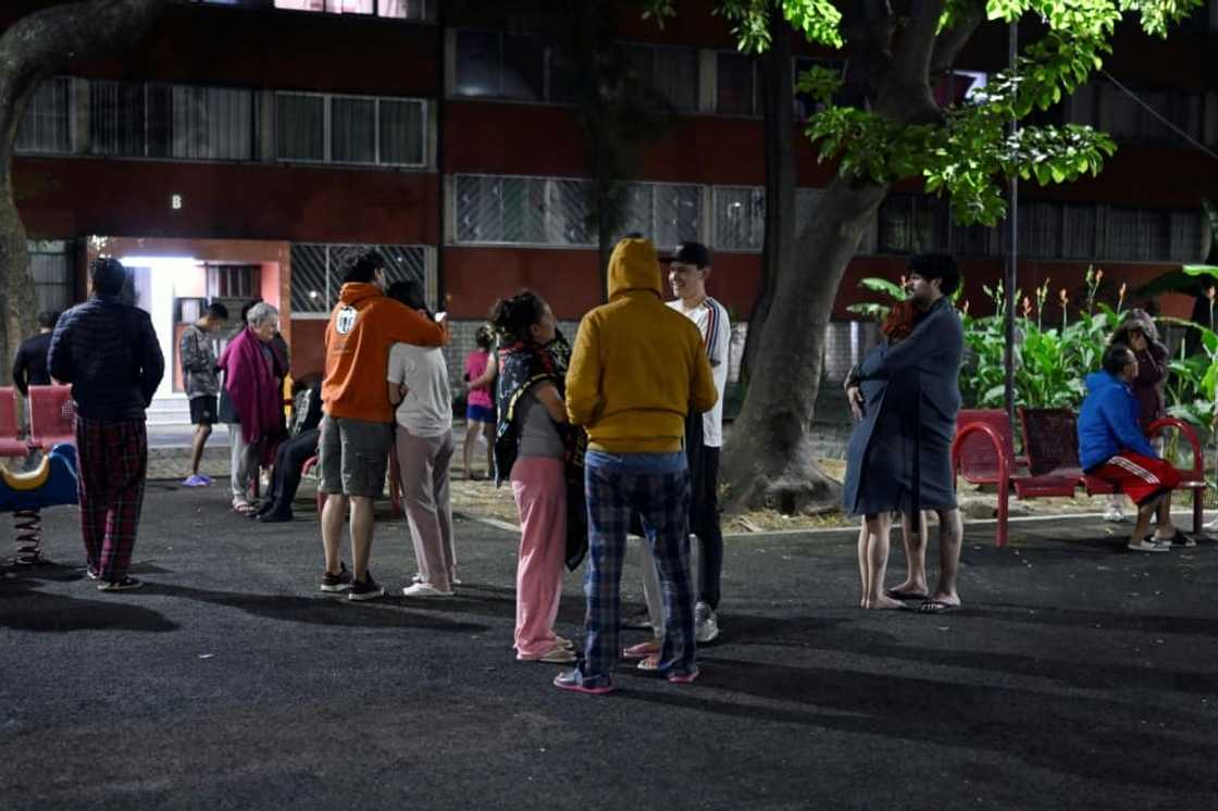 People wait in the streets of Mexico City after a strong earthquake hit overnight