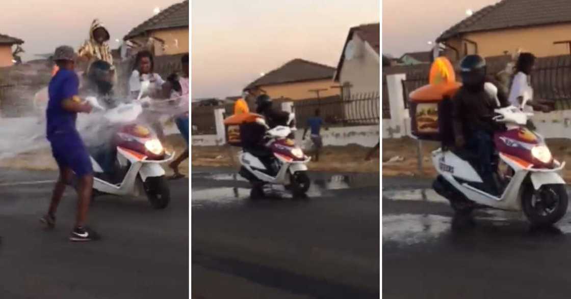 Children throwing water at a delivery man