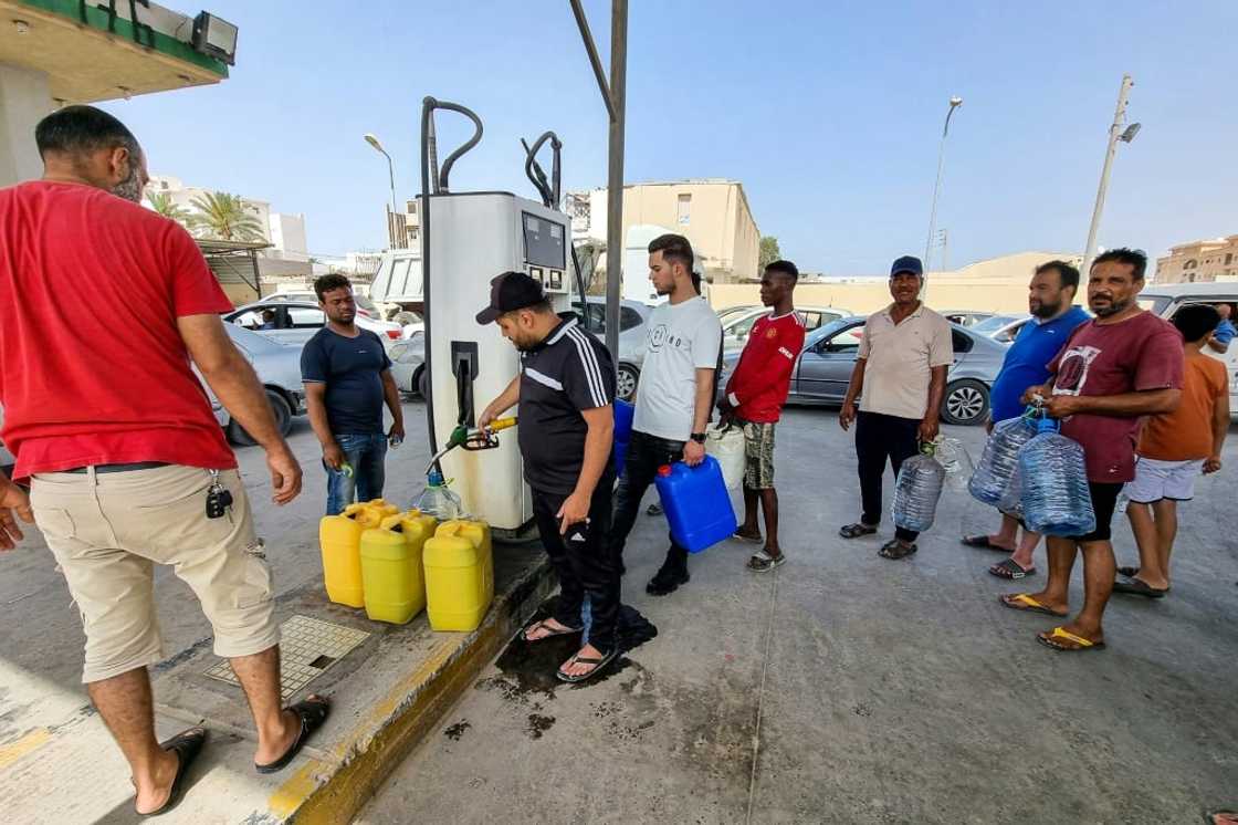 People queue to buy fuel for home electric generators at a petrol station in Libya's capital Tripoli on July 4, 2022 amid frequent blackouts People queue to buy fuel for home electric generators at a petrol station in Libya's capital Tripoli on July 4, 2022 amid frequent blackouts