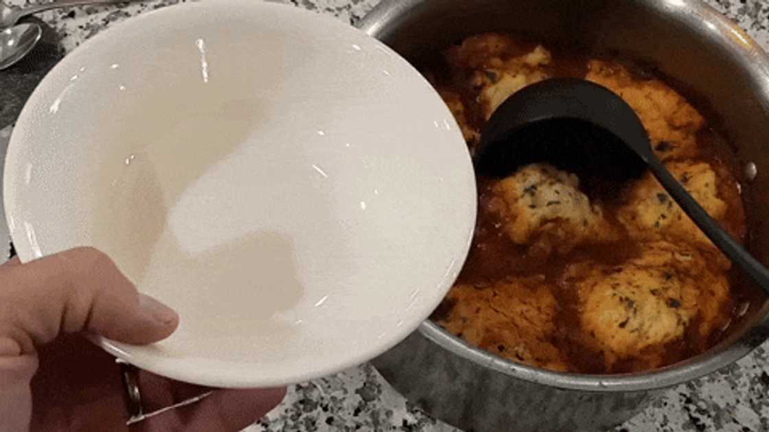 Serving hot beef stew and dumplings dish Serving hot beef stew and dumplings dish