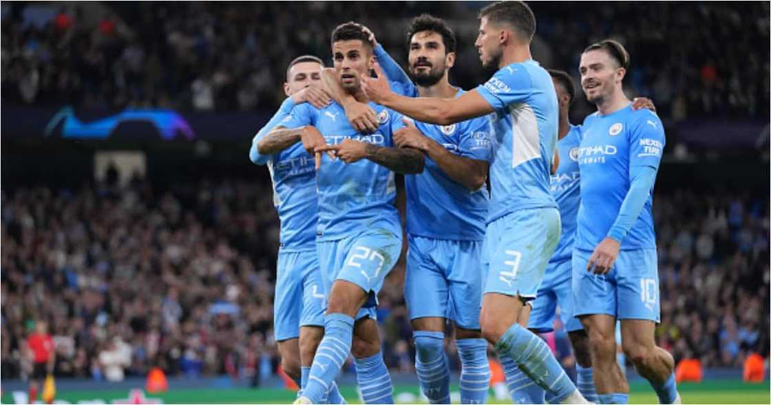 Joao Cancelo celebrates with teammates after scoring their side's fifth goal during the UEFA Champions League group A match against Leipzig (Photo by Matt McNulty - Manchester City/Manchester City FC via Getty Images)