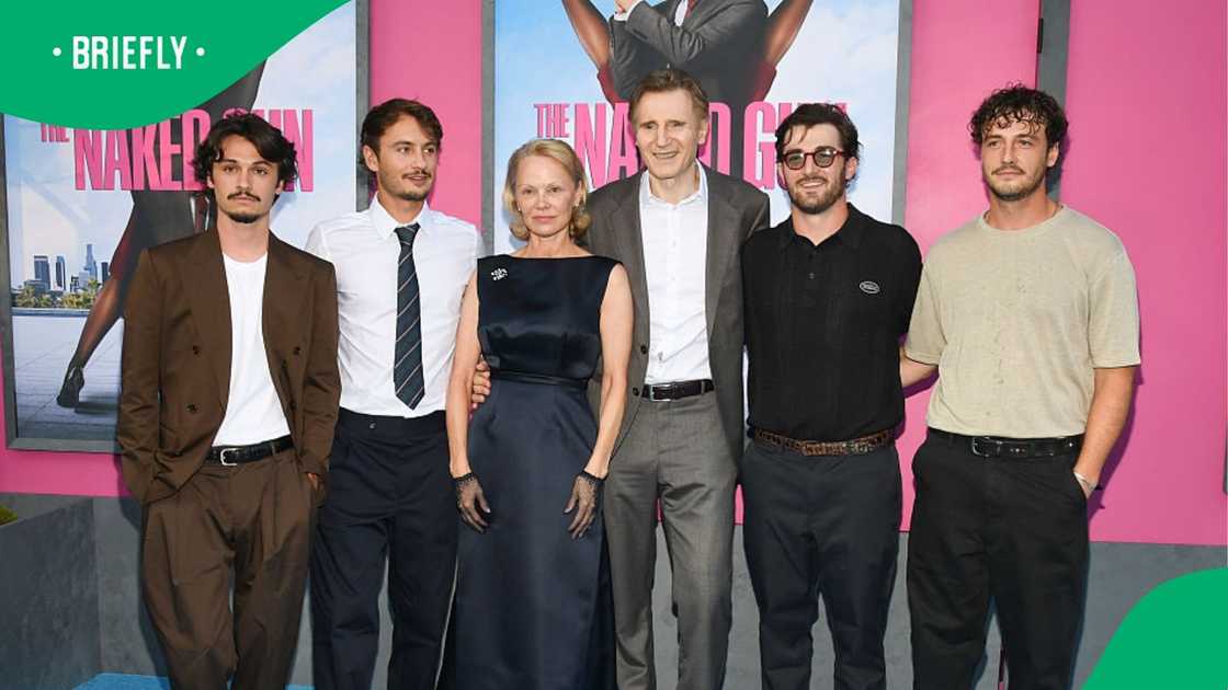Pamela Anderson, Liam Neeson, and their sons pose on the red carpet.