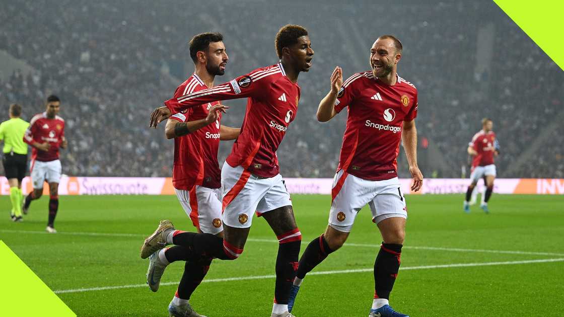 Manchester United stars Bruno Fernandes and Christian Eriksen celebrate with Marcus Rashford after his goal against FC Porto in the UEFA Europa League.