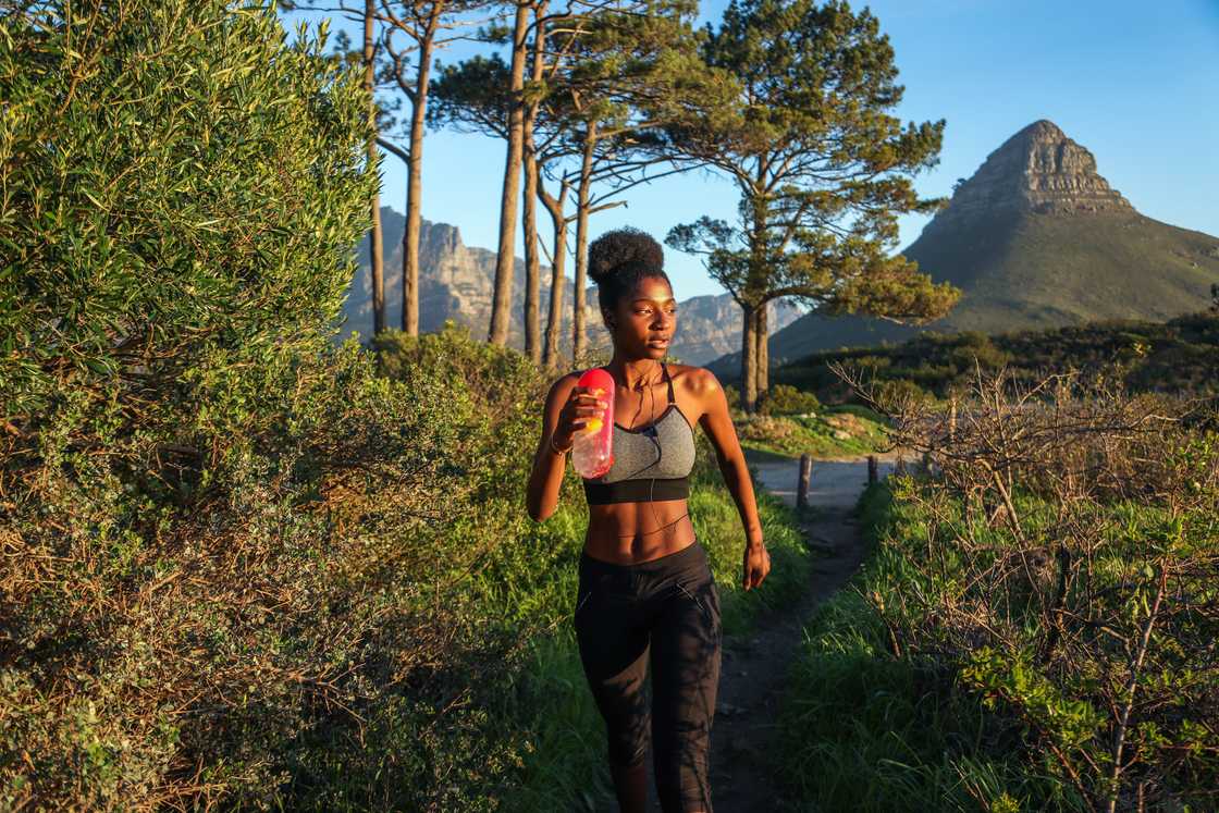 Woman on a hiking trail near Lion's Head in Cape Town.