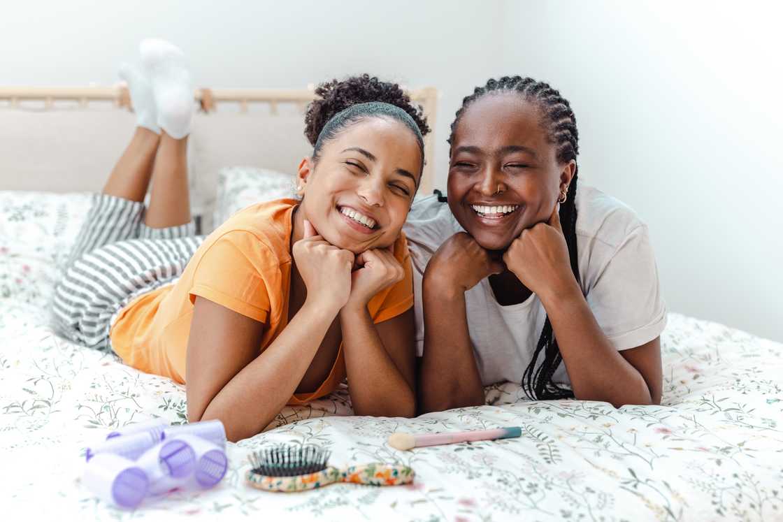 Two young women laughing on a bunk bed. Two young women laughing on a bunk bed.