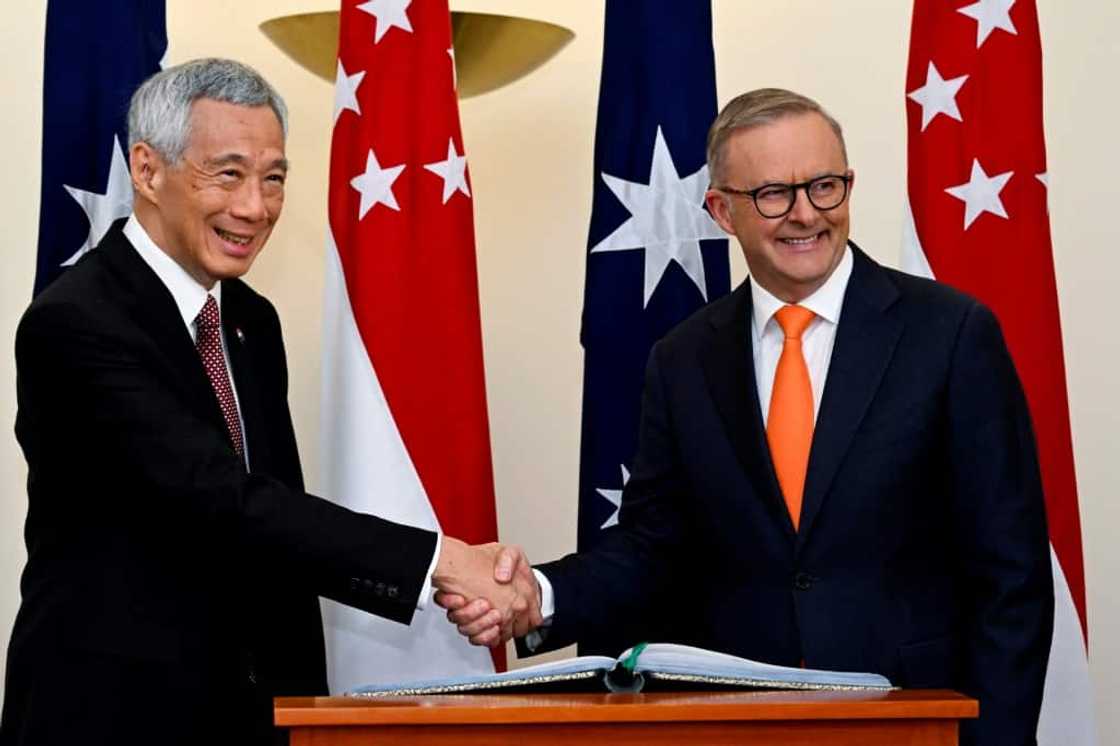 Australia's Prime Minister Anthony Albanese (R) shakes hands with Singapore's Prime Minister Lee Hsien Loong during their meeting at Parliament House in Canberra on October 18, 2022. Australia's Prime Minister Anthony Albanese (R) shakes hands with Singapore's Prime Minister Lee Hsien Loong during their meeting at Parliament House in Canberra on October 18, 2022.