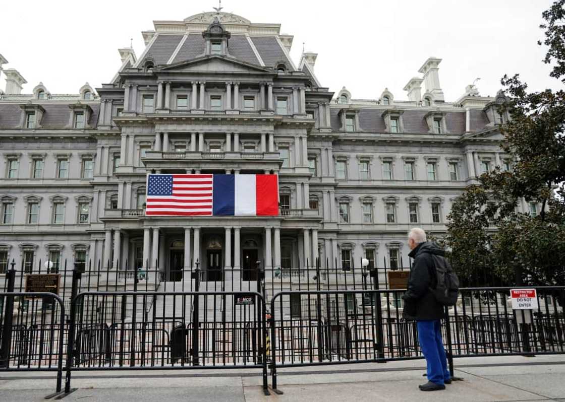 French and US flags adorn the Eisenhower Executive Office Building next to the White House for the state visit of French President Emmanuel Macron beginning