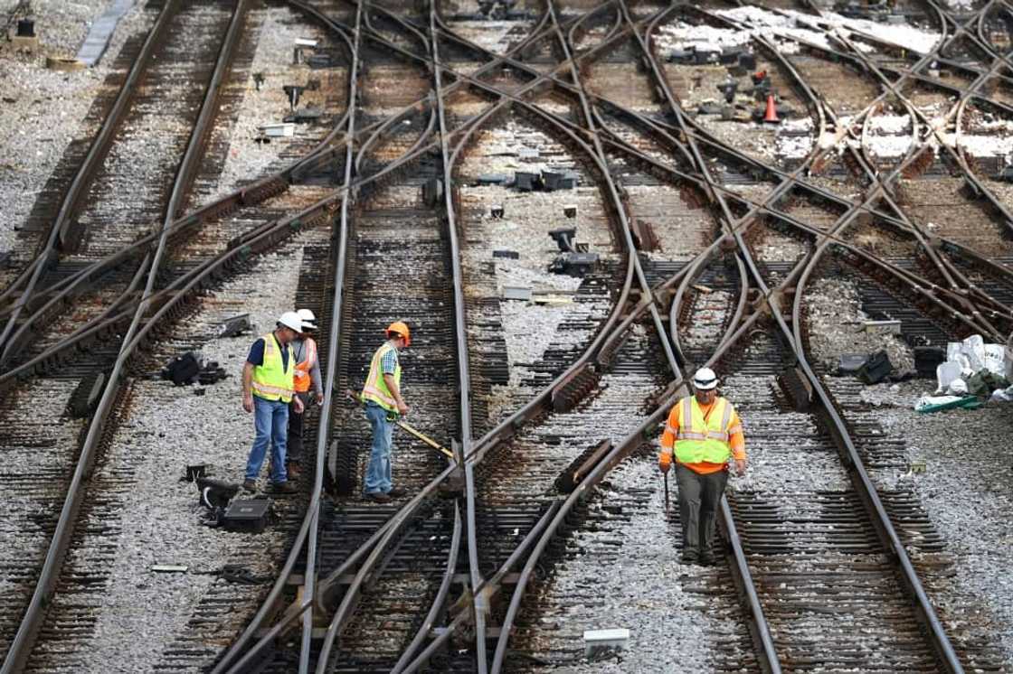 Workers service the tracks at the Metra/BNSF railroad yard outside of Chicago