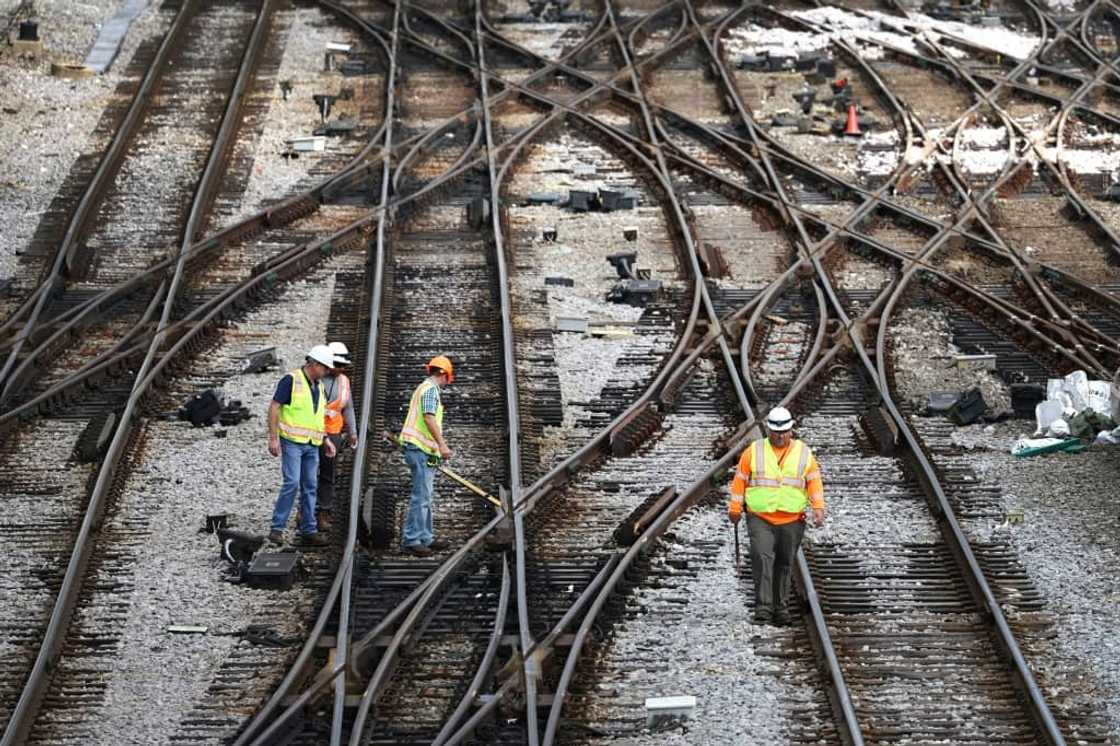Workers service the tracks at the Metra/BNSF railroad yard outside of Chicago Workers service the tracks at the Metra/BNSF railroad yard outside of Chicago