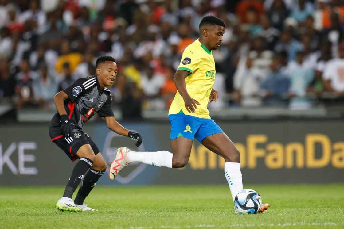 Sundowns midfielder Teboho Mokoena shields the ball away from Pirates midfielder Relebohile Mofokeng