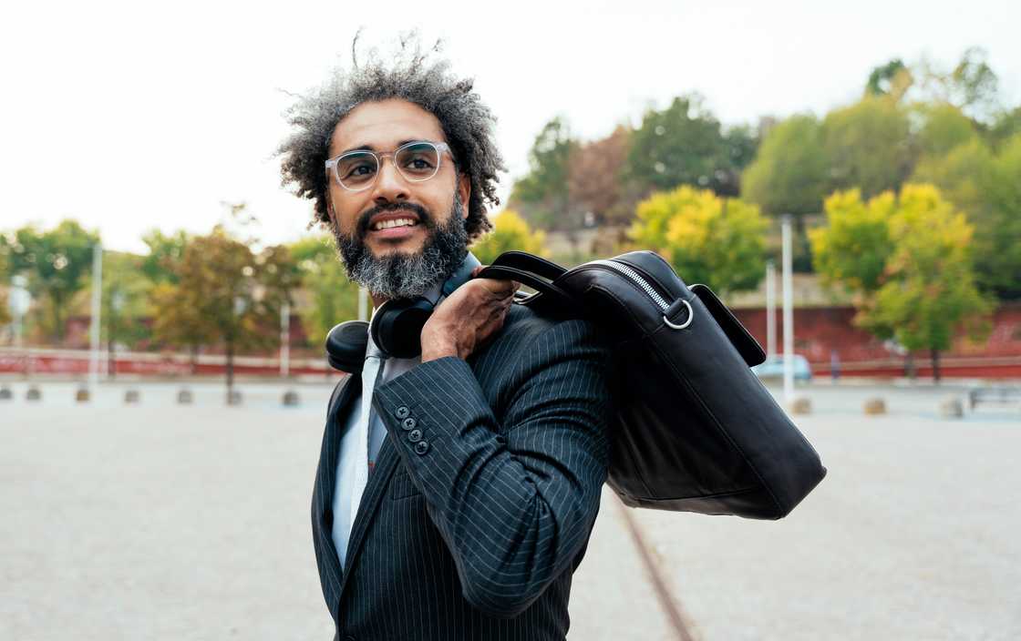 A lawyer walks past the courthouse gates carrying a briefcase. A lawyer walks past the courthouse gates carrying a briefcase.