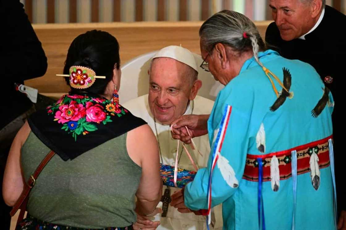 Pope Francis recieves gifts from members of the Indigenous community as he meets with them at the Sacred Heart Church of the First Peoples in Edmonton, Alberta, Canada, on July 25, 2022 Pope Francis recieves gifts from members of the Indigenous community as he meets with them at the Sacred Heart Church of the First Peoples in Edmonton, Alberta, Canada, on July 25, 2022