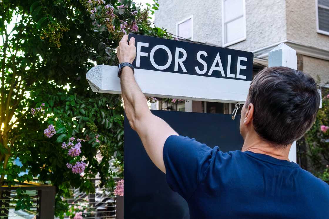 A realtor put up a "For sale" sign on a house