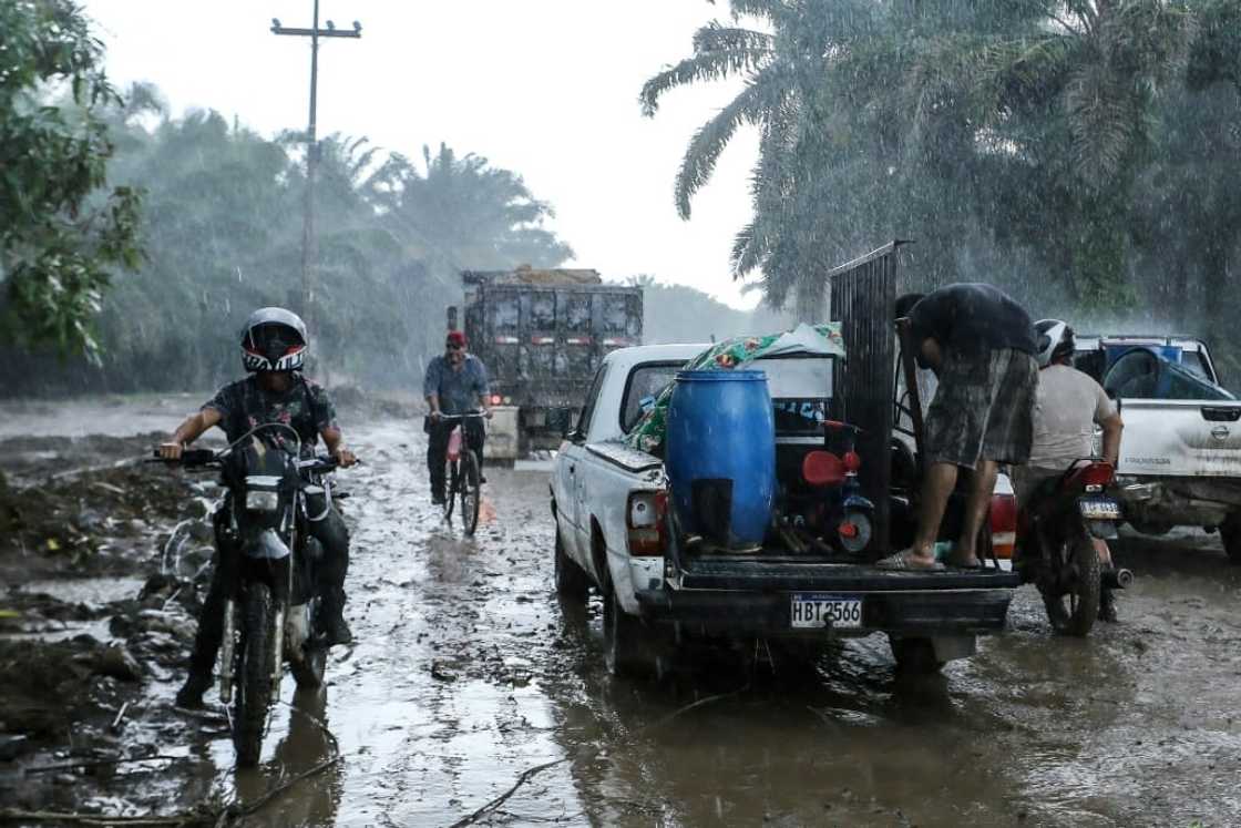 Residents leave their homes in the municipality of El Progreso, Honduras under pouring rain on October 8, 2022 before the arrival of Hurricane Julia Residents leave their homes in the municipality of El Progreso, Honduras under pouring rain on October 8, 2022 before the arrival of Hurricane Julia