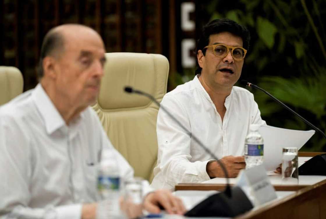 Colombian High Commissioner for Peace, Ivan Danilo Rueda (right), reads a statement with Colombian Foreign Minister Alvaro Leyva, during a meeting with an ELN guerrilla delegation, in Havana