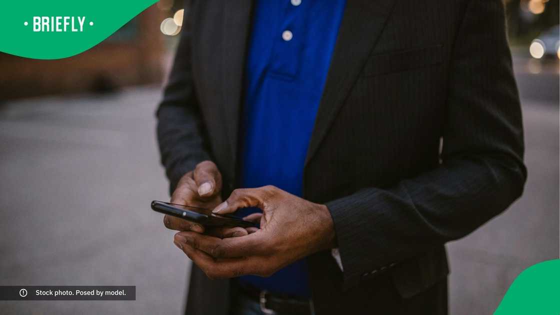 A man typing on the phone. A man typing on the phone.