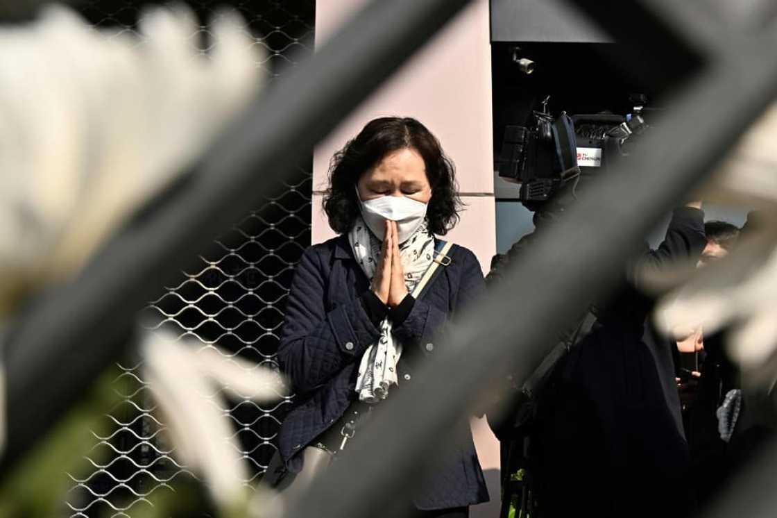 A woman prays in tribute to those who were killed in Seoul's Itaewon district during a Halloween crush at a makeshift memorial A woman prays in tribute to those who were killed in Seoul's Itaewon district during a Halloween crush at a makeshift memorial