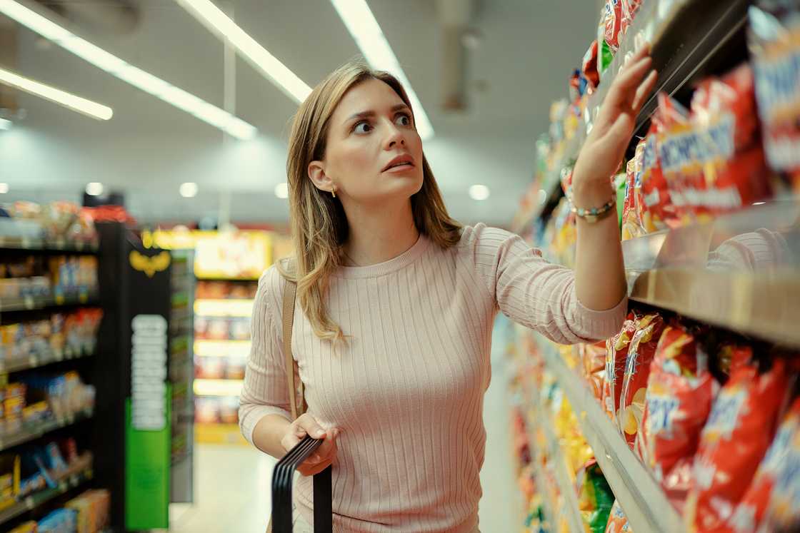 A stock photo of a woman doing grocery shopping A stock photo of a woman doing grocery shopping