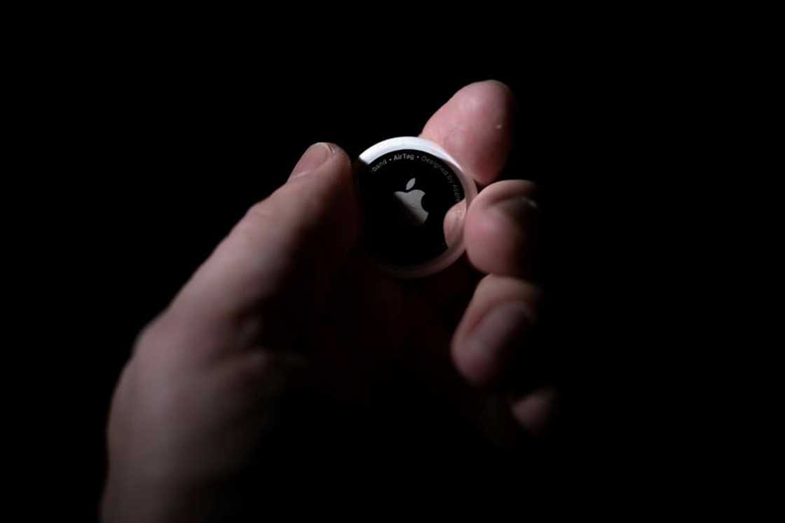 Apple's AirTag is a silver and white gadget about the size of a coin Apple's AirTag is a silver and white gadget about the size of a coin