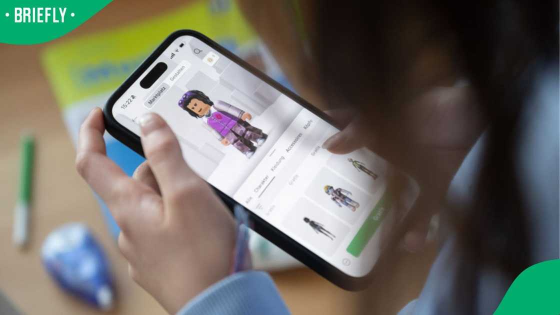 A child playing Roblox on a phone.