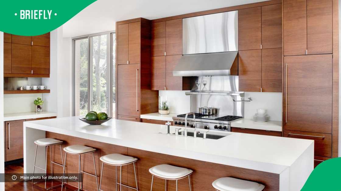 A modern kitchen with breakfast bar and stainless appliances. A modern kitchen with breakfast bar and stainless appliances.