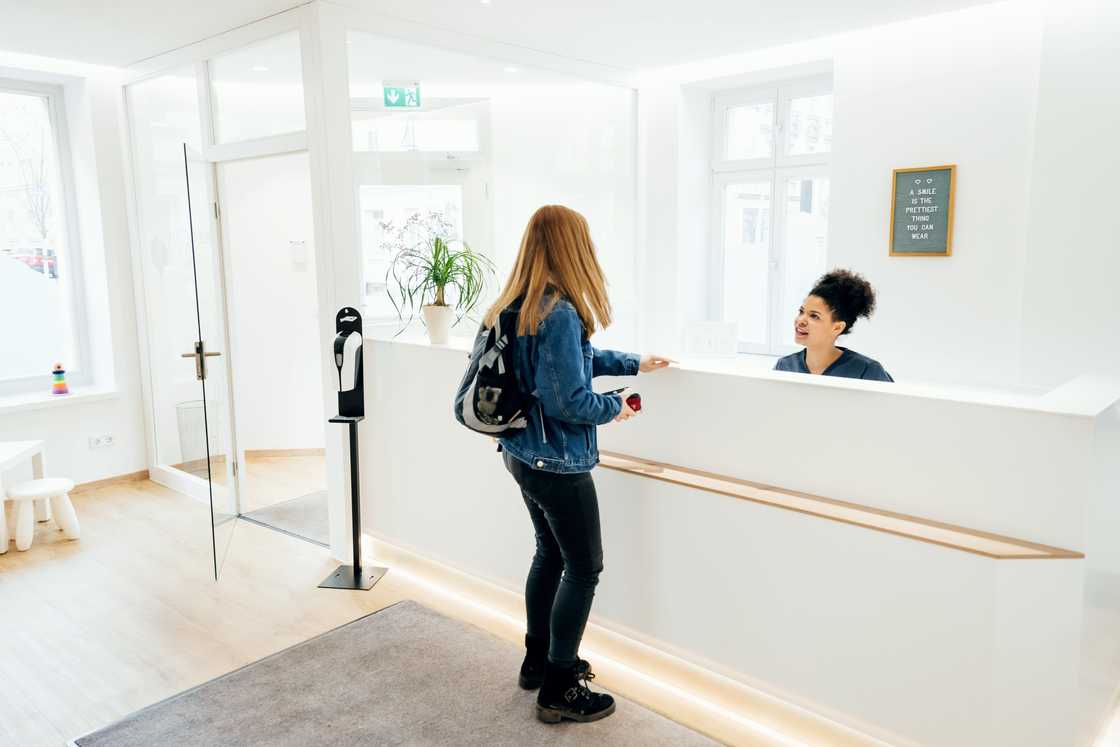 A customer talking to a receptionist