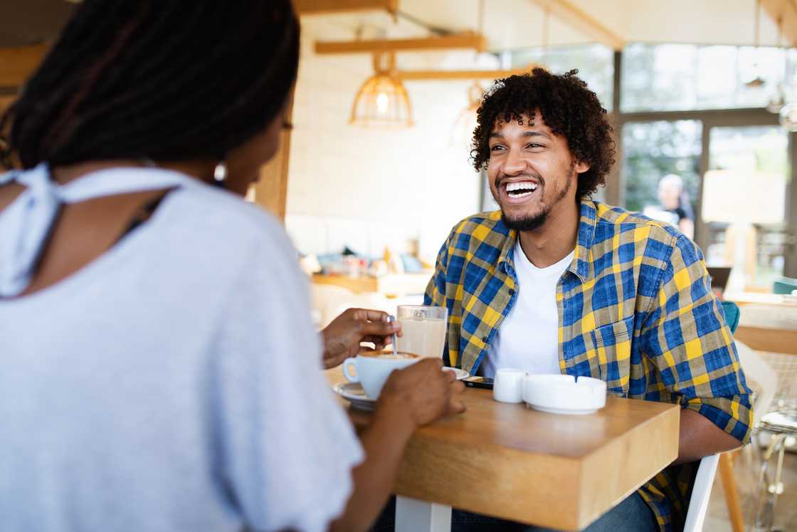 A man and a lady at a cafe chatting