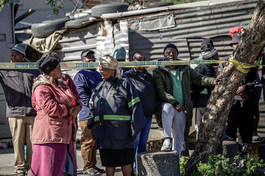 Bystanders look on behind police tape near an entertainment venue in Somerset West on September 27, 2026, after gunmen stormed the premises Bystanders look on behind police tape near an entertainment venue in Somerset West on September 27, 2026, after gunmen stormed the premises