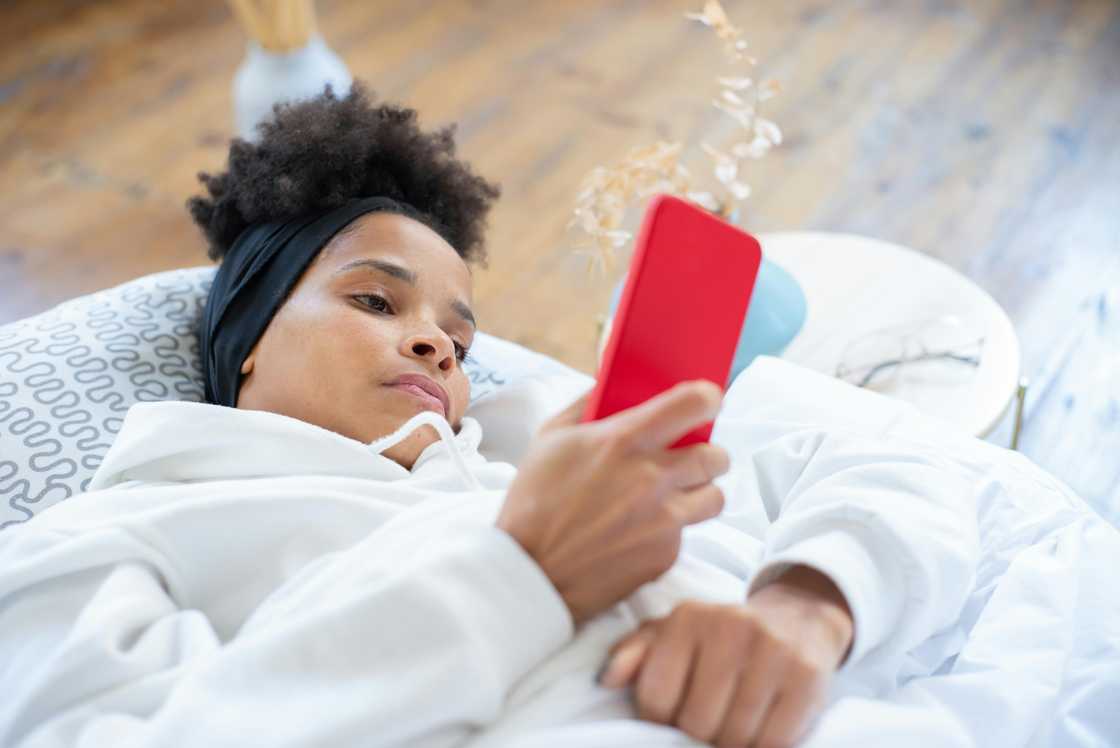 A woman checking her phone in the morning