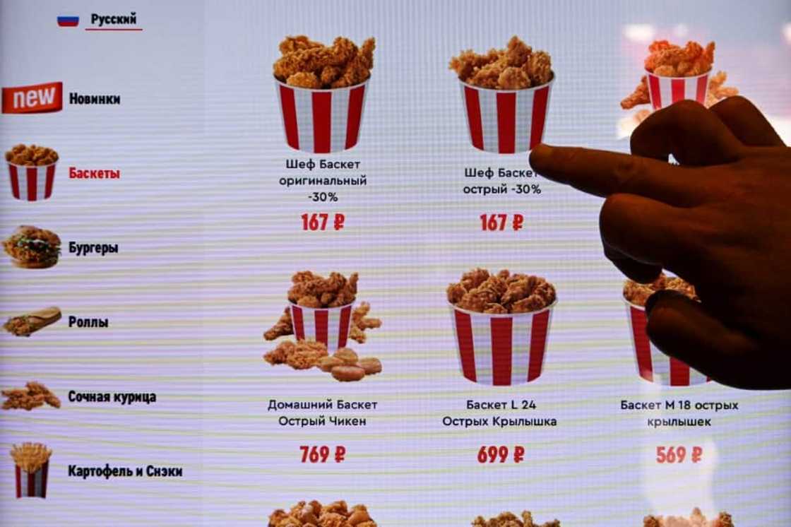 At the Moscow launch, KFC founder Colonel Sanders ws  was absent from Rostic's  logo, but the new colour scheme still featured the signature red and white At the Moscow launch, KFC founder Colonel Sanders ws  was absent from Rostic's  logo, but the new colour scheme still featured the signature red and white