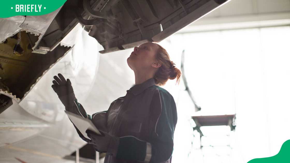 An Aeronautical engineer inspecting an aircraft